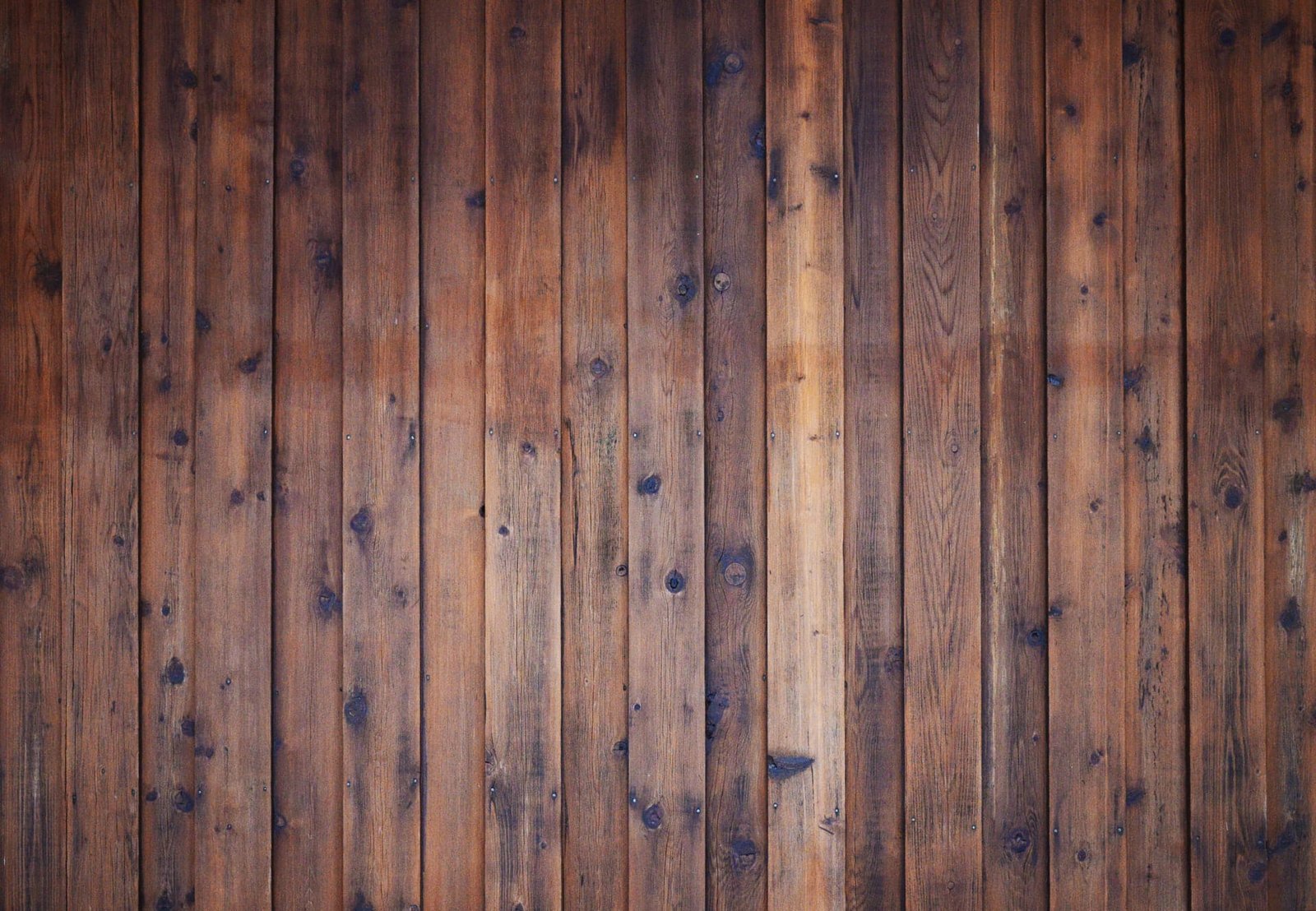 Detail of a stained vertical-board wood fence built by VC Contractor in Longview, WA