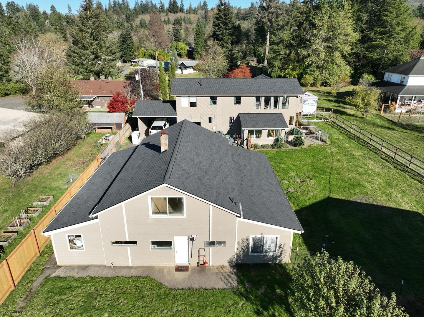 Aerial view of a finished hip-roof shingle replacement on a Cowlitz County home