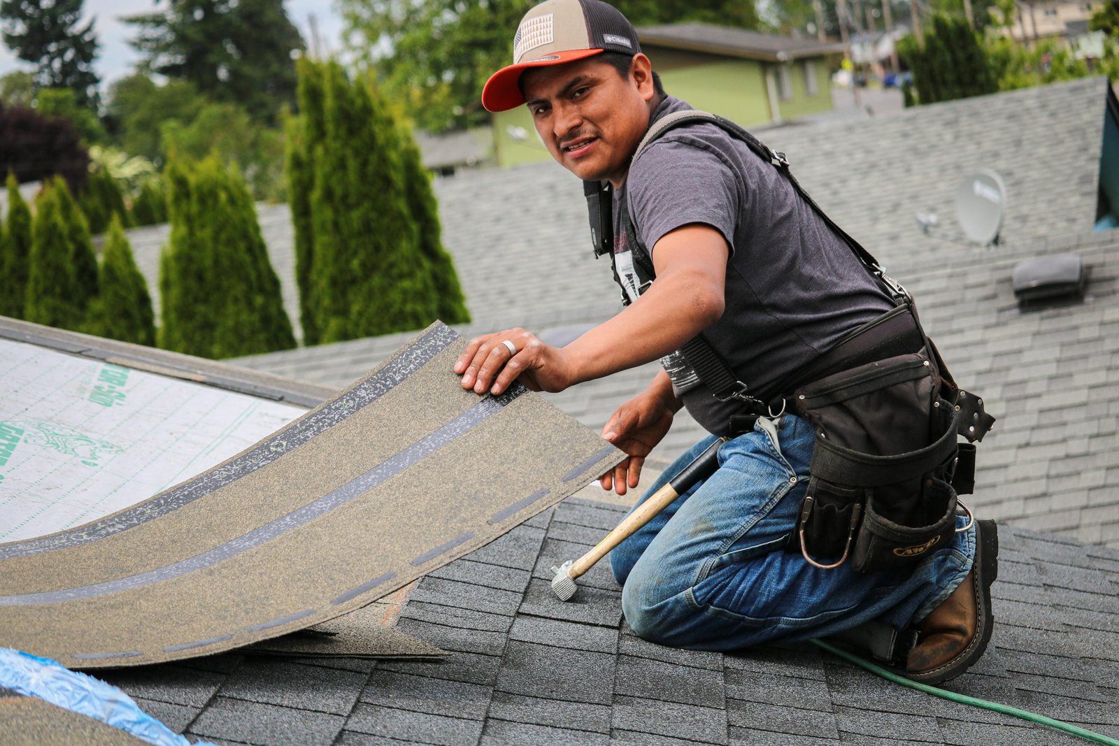 Professional roofer installing underlayment in Longview, WA