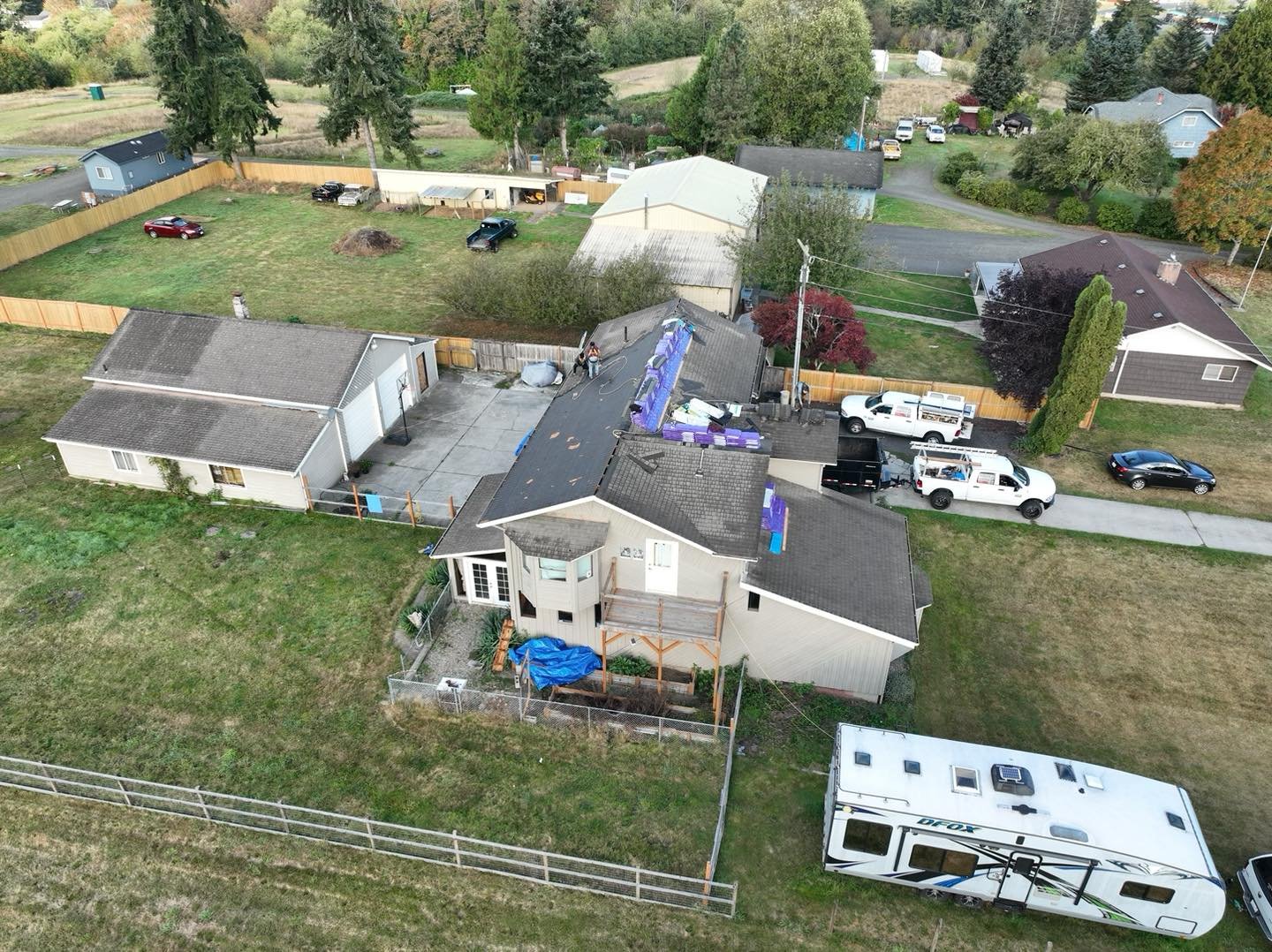 Aerial view of a VC Contractor roofing crew and trucks on a re-roof job in Longview, WA